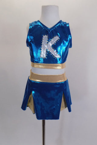 Two piece turquoise & gold cheerleader themed costume has large crystaled “K” at the front & peek-a-boo hole at the back. Comes with matching pleated skort. Front