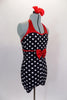 Black and white polka dot short unitard has red metallic banding and halter neck. The waist has a large red metallic bow. Comes with red bow hair accessory. Side