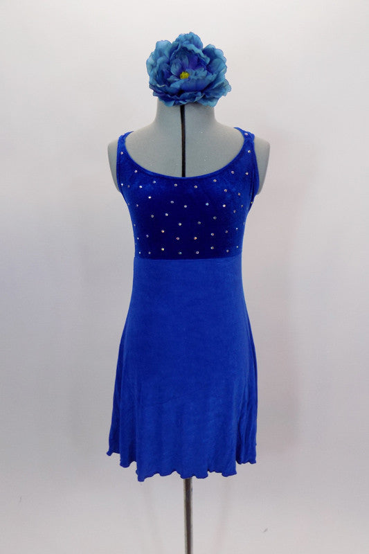Royal blue empire waist leotard dress has crystal covered velvet bodice with double cross back straps. Skirt is a textured crepe stretch that flows nicely. Comes with large floral hair accessory. Front