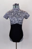 Black and white circular kaleidoscope pattern leotard has black bottom, cap sleeves and high neck with keyhole back. Comes with matching hair accessory. Front