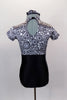 Black and white circular kaleidoscope pattern leotard has black bottom, cap sleeves and high neck with keyhole back. Comes with matching hair accessory. Back