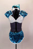 Aqua blue sequined shrug jacket covers a white bra top & separate faux shirt collar with attached black neck tie. The sequined skort has side slits. Comes with matching hat. Front