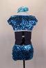 Aqua blue sequined shrug jacket covers a white bra top & separate faux shirt collar with attached black neck tie. The sequined skort has side slits. Comes with matching hat. Back