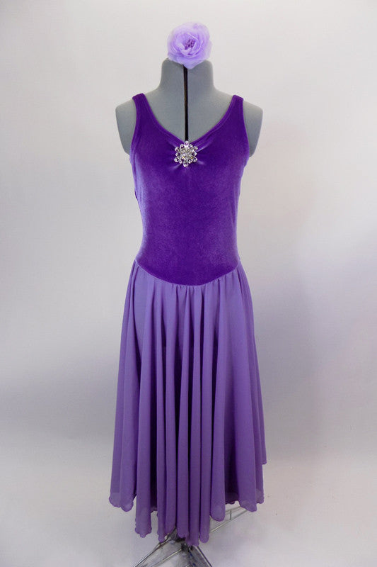 Lavender velvet leotard dress has  pinch front, crystal brooch & low back. Layers of flowing lavender chiffon that make up the knee length skirt.  Comes with lavender floral hair accessory. Front
