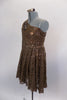 Pale brown sequined lace dress has one shoulder and long sleeve that rests over a lined copper leotard. There is a large beaded applique that sits along right shoulder and bust. Comes with matching hair accessory. Left side