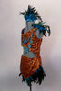 2-piece native inspired costume is orange sequined with teal feathers. Bra  has an asymmetrical shoulder & tie-up sides. Comes with feather trimmed skirt and feather hair accessory. Left side
