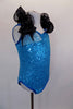 Turquoise sequin leotard has pinch front & halter neck with an attached wide, black curly organza ruffle & adjustable straps. Comes with hair accessory. Right side