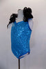 Turquoise sequin leotard has pinch front & halter neck with an attached wide, black curly organza ruffle & adjustable straps. Comes with hair accessory. Left side