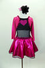 Black leotard has black sheer mesh midriff & black bottom. Has pink glitter skirt &  ¾ sleeved attached jacket style top has pink glitter heart on black bust. Comes with hair accessory. Front
