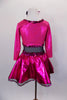 Black leotard has black sheer mesh midriff & black bottom. Has pink glitter skirt &  ¾ sleeved attached jacket style top has pink glitter heart on black bust. Comes with hair accessory. Back
