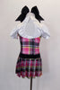School girl themed pink & black tartan dress with rhinestone accent belt has upper chest that has white with pouf sleeves, white shirt collar & keyhole back. Comes with large black hair bow. Back