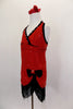 Flapper themed red sequined cross front halter dress has black crystaled piping. Skirt cuts up at left leg with black velvet bow. Edged with black fringe. Right side
