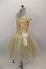 Gold romantic tutu has cream mesh pouf sleeves, cream & gold beaded lace overlay. Long gold & cream crystal tulle skirt has wide waistband with flower detail. Comes with cream floral hair accessory. Left side