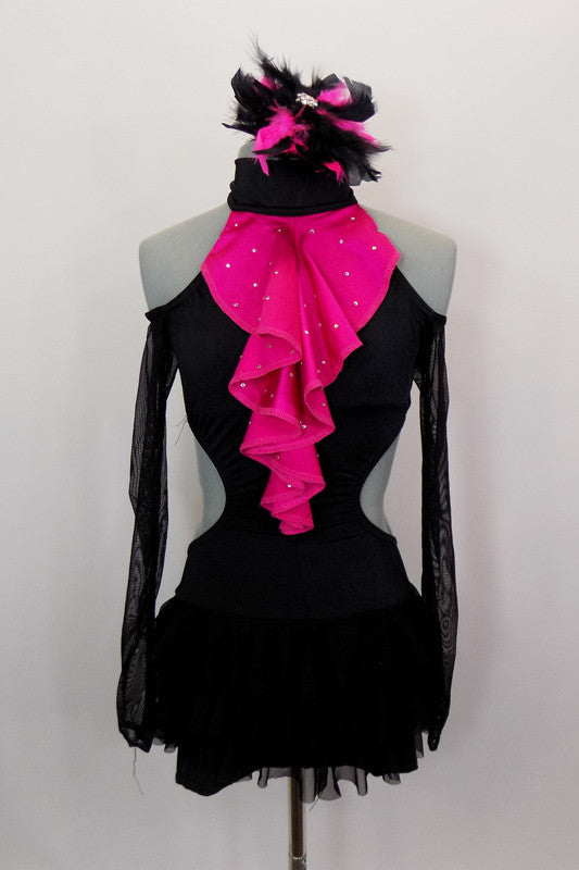 Black high collar halter leotard has bootie shorts, open sides & off shoulder mesh sleeves. There is an attached ruffled black mesh skirt & pink ruffled ascot. Comes with matching hair accessory. Front