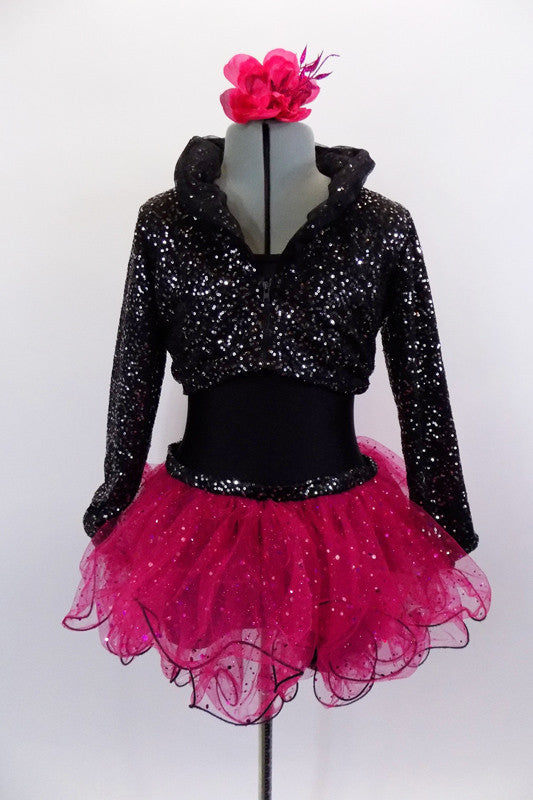 Black camisole style short unitard has attached hot pink sequin dotted curly hem ruffle skirt. Comes with a black & silver sequined short blazer coat. Comes with hair accessory. Front