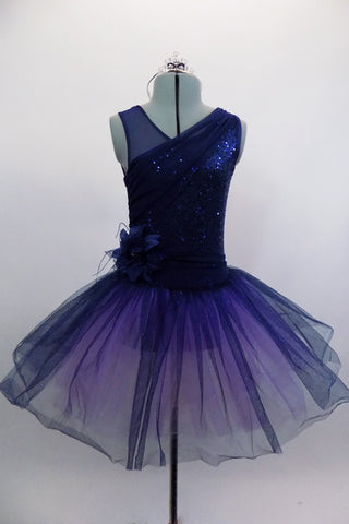 Navy tutu  has asymmetrical sequined bodice. Navy tulle, sits on layers of pale mauve tulle. Wide waistband gathers with a large navy flower on the right hip. Comes with hair accessory. Front