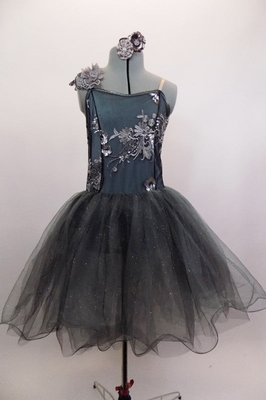 Romantic tutu dress in shades of grey has charcoal crystal tulle over layers of pale grey. The bodice is a charcoal, princess cut styles with embroidered lace. Comes with floral hair accessory. Front
