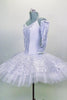 White platter tutu has silver sequined center on white bodice. Has matching silver sequined overlay over white professional tutu. Comes with gauntlets & tiara. Side