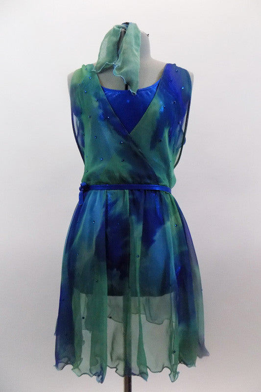Chiffon cross-over dress in shades of blues & greens is covered with crystals & sits over top of an electric blue leotard with matching belt and hair accessory. Front
