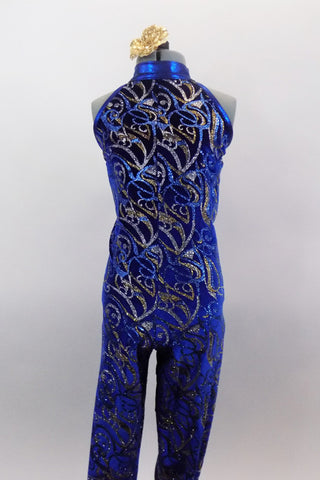 Electric Blue full unitard has high halter collar and four angled back straps. The entire unitard is covered in glittery swirls of silver gold and light blue. Comes with hair accessory. Front