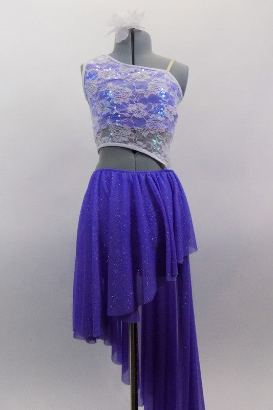 Periwinkle, glitter mesh asymmetrical skirt  is angled short at front & long at back. Skirt is attached to a white, asymmetrical sequined lace top at left hip. Comes with hair accessory. Front