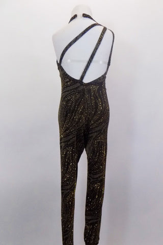 Unitard with stirrup bottoms has wave designs of grey silver & gold on black. Asymmetrical neckline & low back has double straps from right shoulder. Back