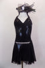 Black short unitard dress has V-front halter neckline connected to sheer black mesh back. Has attached open front black glitter mesh skirt & jeweled waist. Comes with matching hair accessory. Front
