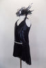 Black short unitard dress has V-front halter neckline connected to sheer black mesh back. Has attached open front black glitter mesh skirt & jeweled waist. Comes with matching hair accessory. Side