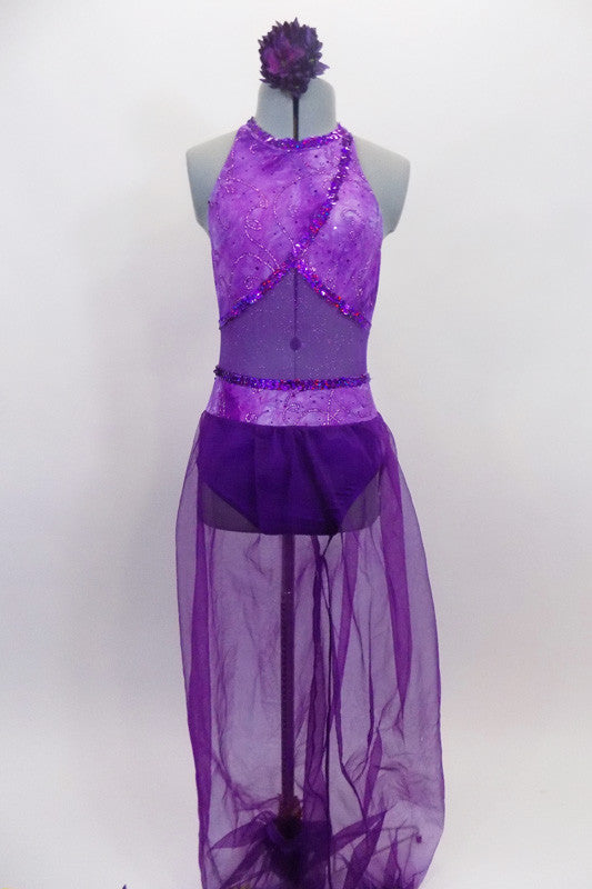 Purple Arabian themed 2-piece costume has halter style leotard with light purple, cross-over front, purple glitter mesh middle & dark purple bottom. Matching purple sheer harem pants have light purple waist. Comes with hair accessory. Front