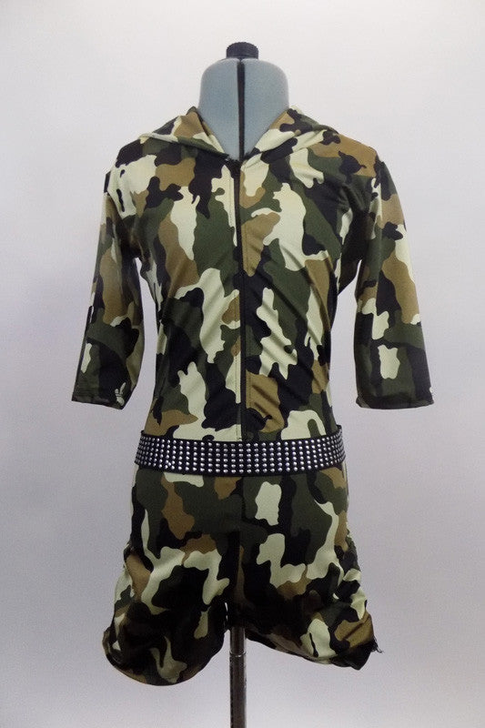 Army themed, camouflage, lined short unitard has front zipper & three quarter sleeves. It features an attached black studded belt & a hood collar. Front