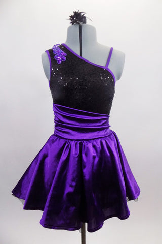 Purple & black asymmetrical dress has black sequined, torso with purple banding & purple sequined applique. Purple satin skirt has cummerbund waist & petticoat. Front