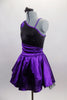 Purple & black asymmetrical dress has black sequined, torso with purple banding & purple sequined applique. Purple satin skirt has cummerbund waist & petticoat. Left side