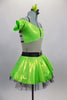 Lime green dress has nude torso with attached green bra top that has cap sleeves. Back has triple black straps joined by crystal ring. Skirt had black petticoat & crystal accents. Comes with hair accessory. Right side