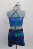 Turquoise iridescent, silver swirl two -piece costume has half top with cross back straps and crystal brooch accent. The matching shorts have a teal glittery waistband with crystal ring buckle accent. Comes with matching hair accessory. Back