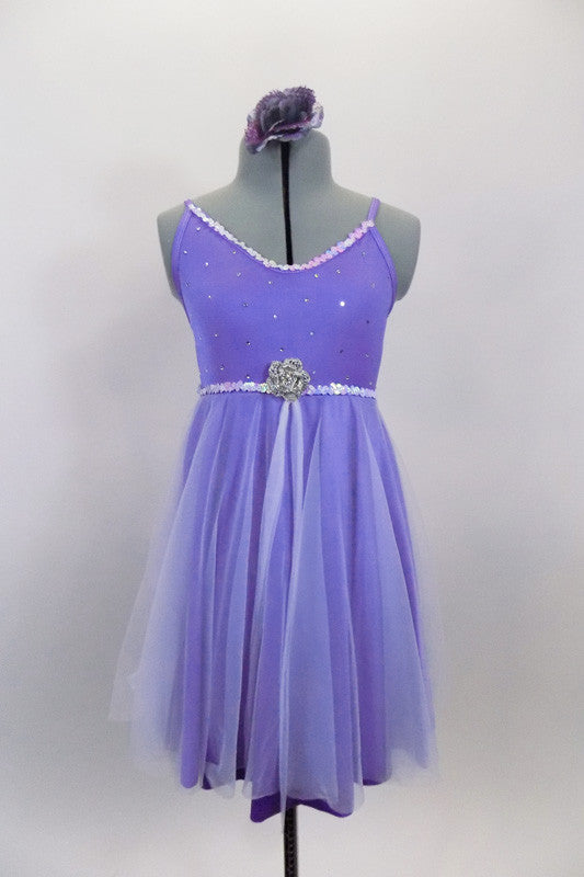 Lavender dress has sequin accented bust & waist with crystaled front, rose brooch accent & cross back straps. Skirt has white sheer on lavender lycra fro flow. Comes with rose hair accessory. Front