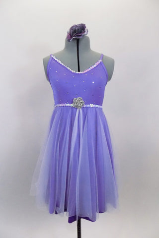Lavender dress has sequin accented bust & waist with crystaled front, rose brooch accent & cross back straps. Skirt has white sheer on lavender lycra fro flow. Comes with rose hair accessory. Front