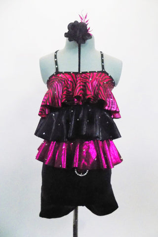 Black & fuchsia short unitard has 3-layered ruffled torso of pink/black zebra print,  black &  shiny fuchsia The ruffles and straps are covered with crystals to match belt buckle. Front