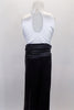 Black & white jumpsuit has white tank style upper with tuxedo shirt front, keyhole back & black bow tie accent. Black sequin pants have cummerbund waistband. Comes with black sequined hat. Back
