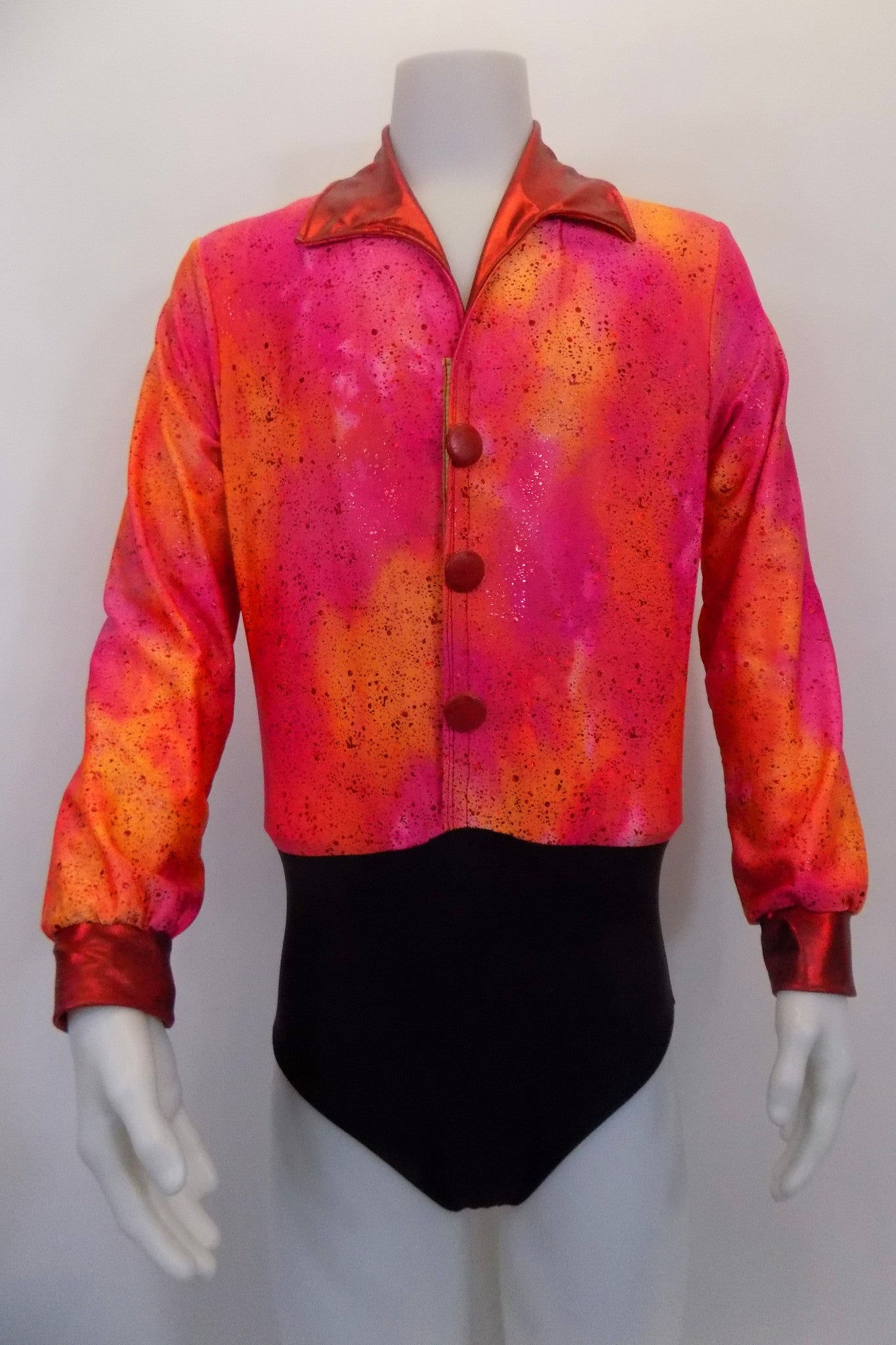 Orange speckled shirt has red metallic collar red faux buttons and attached black brief to keep shirt inside pants. The front of shirt has a series of snaps for good closure. Front