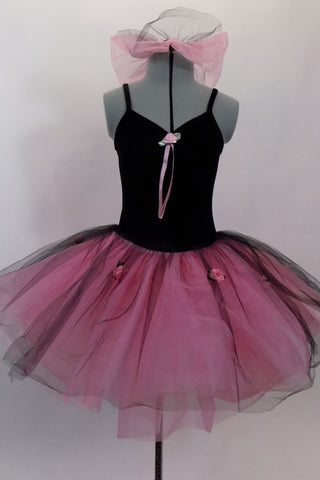 Black velvet camisole leotard dress with pink satin roses has an attached romantic tutu skirt in layers of pink nylon mesh with black tulle overlay. Comes with hair bun ruffle. Front