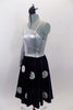 Silver metallic one shoulder long sleeve leotard is accompanied by navy blue velvet skirt with large crystalled silver buttons. Skirt has ruffled petticoat. Comes with hair accessory. Left side