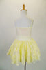 Pale yellow-cream dress has cream sequined pinch-front camisole bodice with rose-ribbon lace skirt over tulle petticoat. Has starburst waist and hair accents. Back
