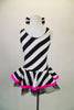 Sweet black and white striped tank dress with hot pink accent makes a statement. Has black tulle petticoat beneath the skirt. Comes with large black & white hair bow. and pink gauntlets. Back