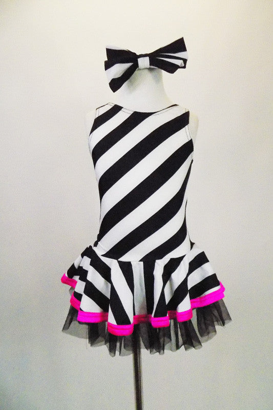 Sweet black and white striped tank dress with hot pink accent makes a statement. Has black tulle petticoat beneath the skirt. Comes with large black & white hair bow. and pink gauntlets. Front