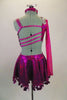 Fuchsia one sleeved costume has cut-out sides that attach at right hip. Back has angled straps, & sequined shoulder applique. Skirt has large dangling sequins. Comes with crystal hair barrette. Back
