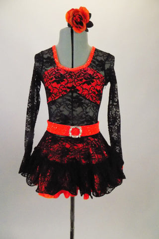 Black lace dress has glittery orange underlay at skirt and bust area & bright orange neckline & belt with crystal buckle for bling. Comes with hair accessory. Front