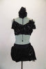 Black 2-piece costume has bra top covered with beaded floral applique. Chiffon cascades on back and over brief bottom, gathering at hip with floral appliques.. Comes with matching hair accessory. Front