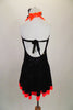 Black & bright orange halter dress has crystal covered orange front center & skirt ruffle. The back is open & ties at both center & neck. Comes with hair accessory. Back
