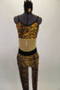 Tiger print unitard has nude mesh center to create illusion of a 2-piece. The back has bra closure and adjustable straps.. Comes with hair accessory. Front