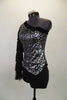 Black & silver asymmetrical top has silver & black pattern & a single sleeve of layered black fringe. Comes with black high waisted shorts & hair accessory. Left side